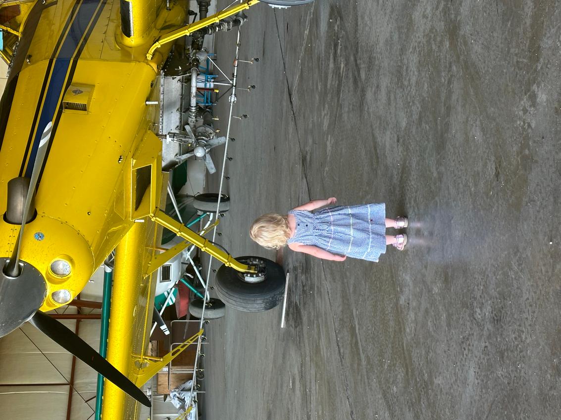 A image of a plane with a kid in front