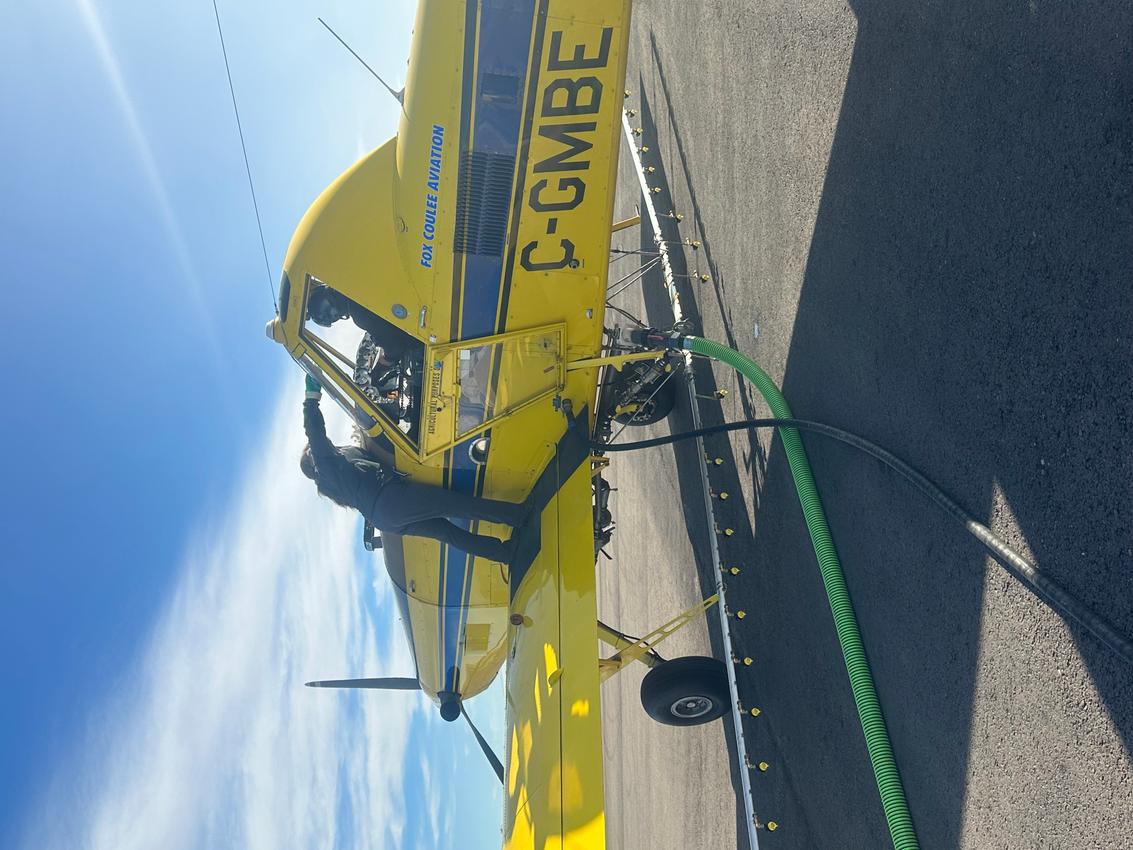 A image of a plane with a pilot and a staff on it